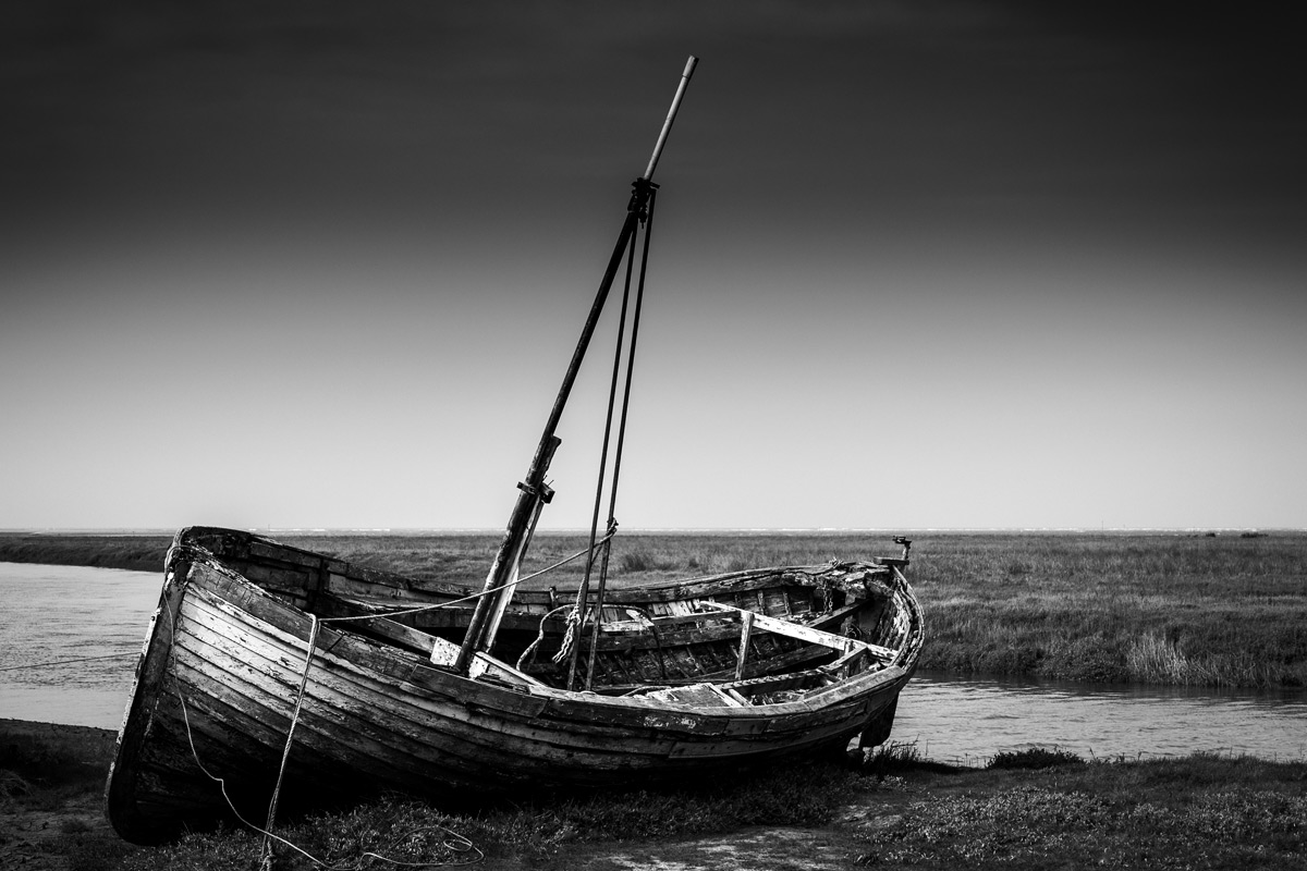 An abandoned decayed wooden boat.