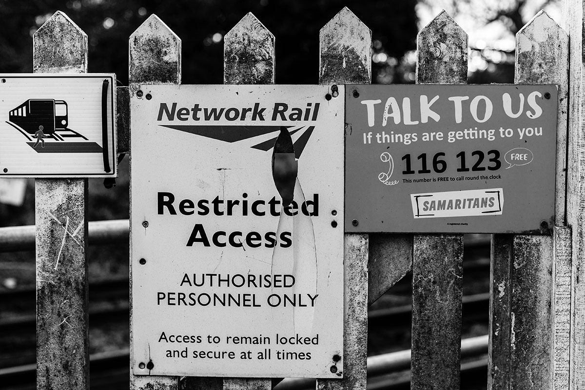 Samaritans sign at train crossing.