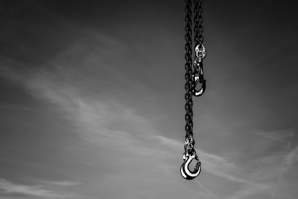 Industrial chains hanging down showing visual gravity.