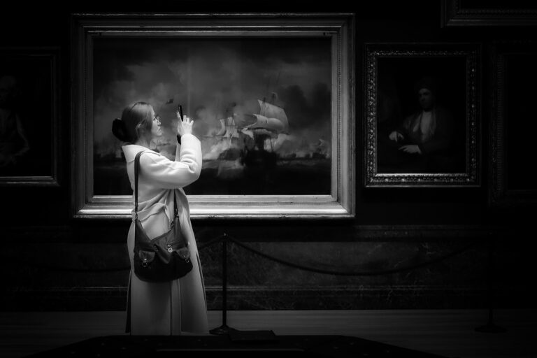 Paintings from the past being photographed on a mobile phone today.