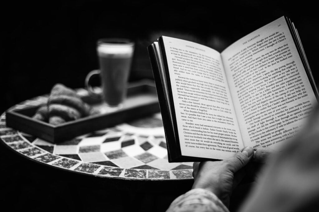 Taking some me time reading a book and having a coffee.