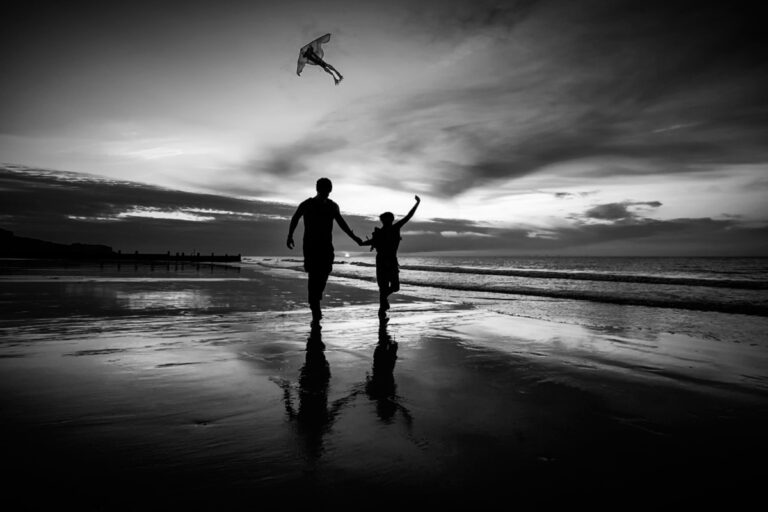 A young couple together at sunset on the beach.